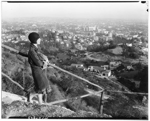 Woman standing on a mountain overlooking Los Angeles