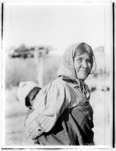 Portrait of a Chemehuevi Indian woman carrying a child on her back, ca.1900