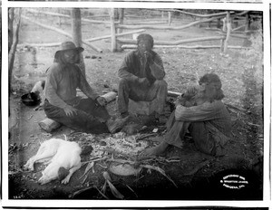 Three Havasupai Indian man sitting around a campfire telling stories, ca.1899