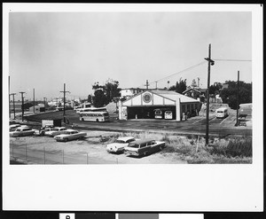 Cars parked near a bus barn, formerly Pacific Electric Railway, ca.1975