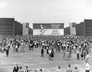 Large banner hanging on the side of the Douglas Aircraft Company plant in Long Beach during World War Two, 1943