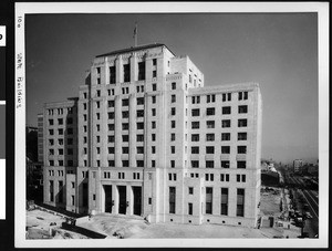 Exterior view of the front of the State Building under construction, 1920-1929