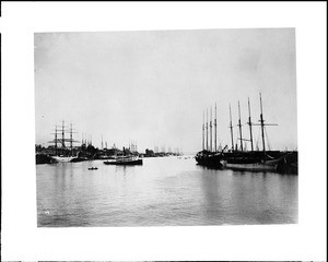 View of the early San Pedro Harbor, showing a tugboat and canoe, ca.1905