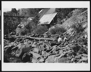 Three men working at Placer mining operation near Lake Alamur, Deer Creek River, 1906