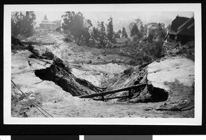 Flood damage to Hollywood Boulevard 800 feet southeast of Kings road, showing hillside houses, 1931