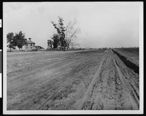 View of a plowed field, showing a homestead in Los Angeles, ca.1910-1919