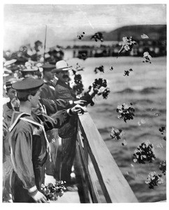 Navy men and civilians casting flowers into the sea at the Santa Monica pier, 1925-1935