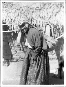 Maria Casseri, a Coahuilla Indian woman, using the "red" or carrying net suspended from her head, California, ca.1899