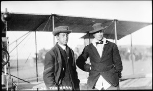 Aviator Tom Gunn posing for a picture with one of the Eaton brothers at the Dominguez Hills Air Meet, ca.1925