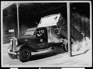 Department of Public Works truck dumping its load