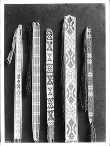 Collection of five pieces of Sioux Indian bead work (belts?) on display, ca.1900