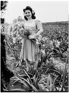 Woman standing in a field of plants