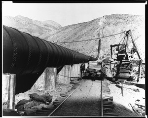 View of construction of the Los Angeles Aqueduct, showing a wooden track, ca.1910-1920