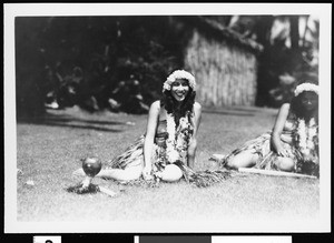 Hawaiian women sitting in grass