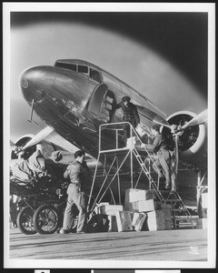 Men loading a Douglas DC-3 airliner, April 1940