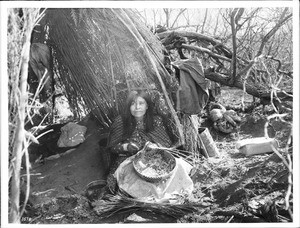 Portrait of an Apache Indian woman making baskets, ca.1900