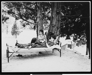 Two women relaxing outdoors, ca.1910