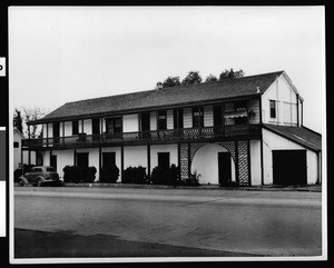 Exterior view of the two-story adobe home of Don Domingo Oyharzabal, showing its garage, San Juan Capistrano, ca.1930