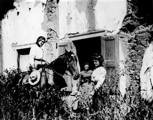 Three women outside of the Pio Pico adobe on Whittier Road, ca.1900