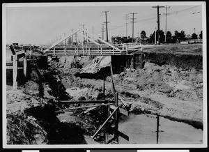 Small wooden suspension bridge over construction area