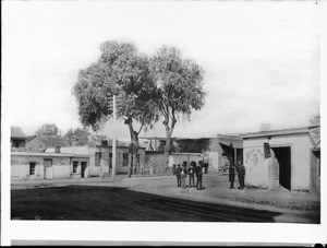 Six men stand ouside of the Magnolia Saloon at New High Street and Marchessault Street, Sonora Town, 1885-1887