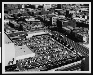 Panoramic view of Los Angeles, showing large parking lot adjacent to a street, August 1962