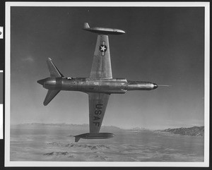 Air Force Lockheed F-94C jet in flight, showing the plane tilted on its side, ca.1960