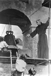 Painting "Hanging the Mission Bell", depicting a friar and young men doing so, ca.1900