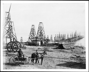 Horse-drawn carriage on the edge of a Summerland oil field, 1902