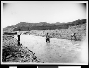 Men measuring flood stream