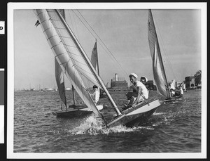 Close-up view of boys riding a sailboat, ca.1940