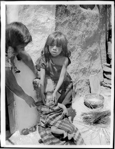 Young Hopi Indian girl with a baby, ca.1900