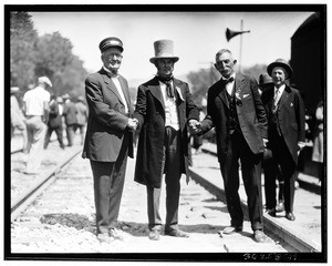 "Wedding of the rails", showing three men shaking hands, 1926