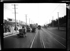 Streetcars and automobiles on an unidentified road