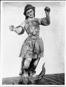 Close-up of a statue of the Archangel San Raphael at Mission Santa Barbara, ca.1905