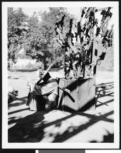 View of man sleeping in front of Mission San Gabriel