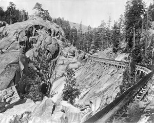 Lumber flume cutting through rocky terrain in Fresno County, California, ca.1905