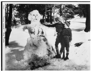 Two children beside a snow sculpture at Big Pines