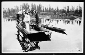 Man on a decorated boat on a lake in Xochimilco, Mexico