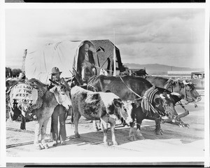 Travelers and an ox-drawn wagon on the road east from Oregon, ca.1932