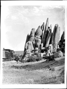A train passes The Spires in the valley of Granite Dells near Prescott, Arizona, ca.1900