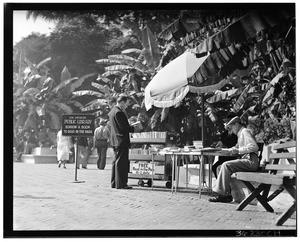 Man borrowing a book from the Los Angeles Public Library in the park