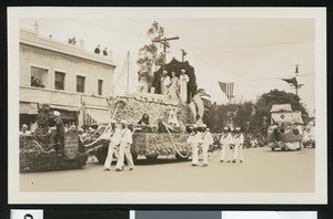 Float and marching sailors in a parade, ca.1920