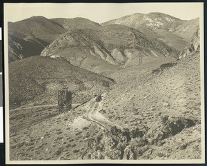 View of Estelle Mines Corporation property, showing an automobile making its way down a dirt road, ca.1900