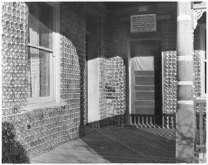 Detailed view of the porch of "The Bottle House", a house made of bottles near Rhyolite, Nevada, ca.1915