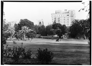 View of Lafayette Park, showing people seated on benches, ca.1920-1929