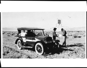 Motorist getting directions in the Mojave desert, 1928