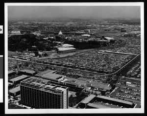 Aerial view of Disneyland Amusement Park, showing the parking lots at right, 1967