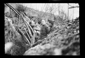 Three soldiers smoking pipes in a trench during World War I, ca.1916