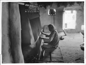 Hopi Indian man weaving a blanket, ca.1900